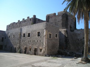 The prison, a palm tree, and the short tower is part of the Arabic section.